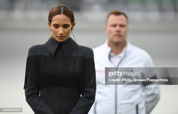 Singer Laura Wright and Umpire Martin Saggers observe a minute of silence before the third day of the third Test between England and South Africa at...