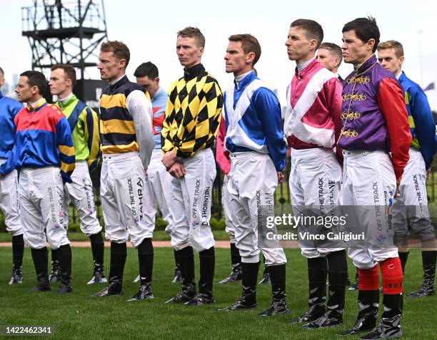 Craig Williams is seen in Her Majesty Queen Elizabeth II racing colours as Jockeys and officials observe a minutes silence in memory of Her Majesty...