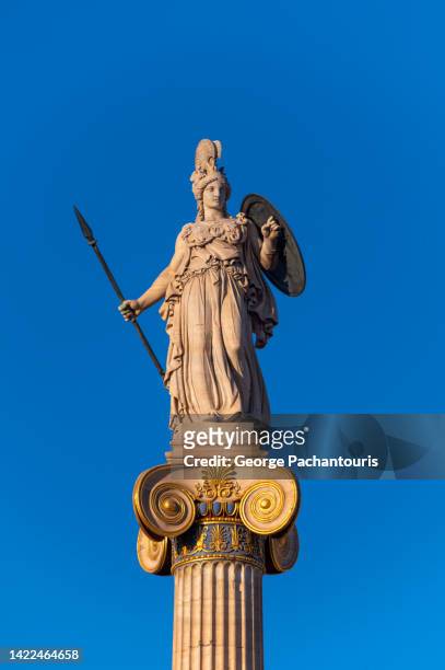 statue of goddess athena ιand the clear blue sky - estatua griega fotografías e imágenes de stock