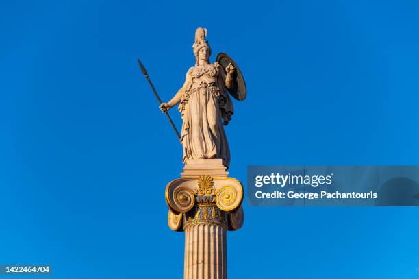 statue of goddess athena with sunset colors - minerva stock-fotos und bilder