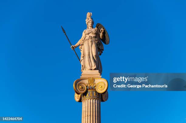 statue of goddess athena with sunset colors - grecia antigua fotografías e imágenes de stock