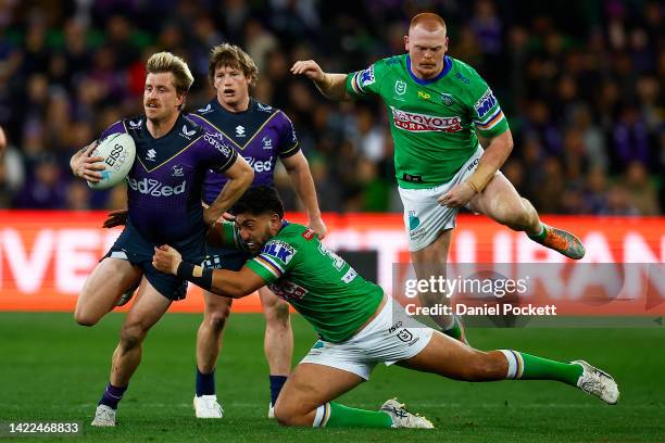 Cameron Munster of the Storm is tackled by Emre Guler of the Raiders during the NRL Elimination Final match between the Melbourne Storm and the...