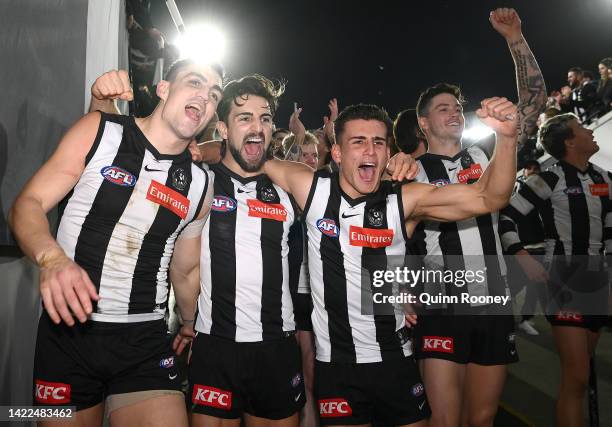 Brayden Maynard, Josh Daicos and Nick Daicos of the Magpies celebrate winning the AFL First Semifinal match between the Collingwood Magpies and the...