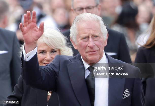 King Charles III and Camilla, Queen Consort view floral tributes to the late Queen Elizabeth II outside Buckingham Palace on September 09, 2022 in...