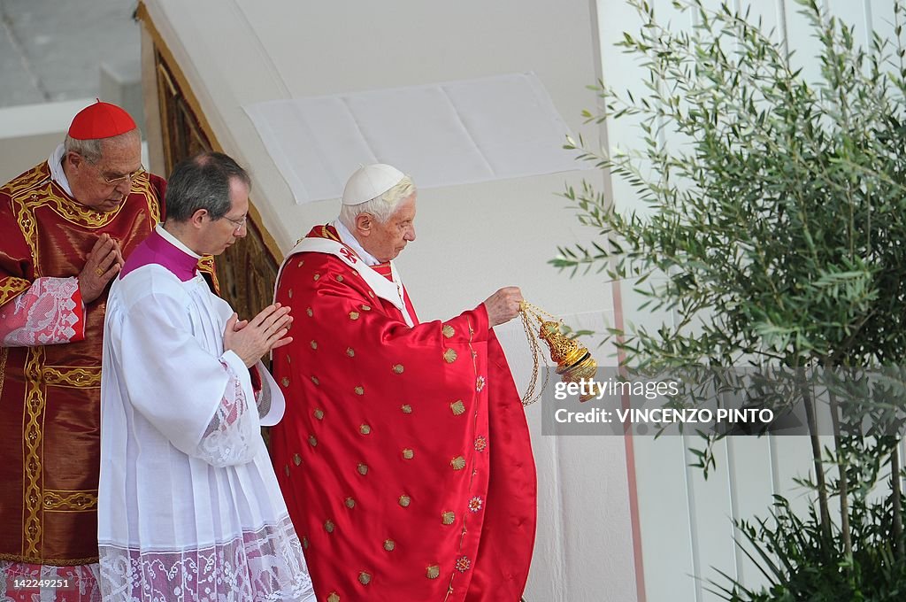 Pope Benedict XVI (R) swings a thurible