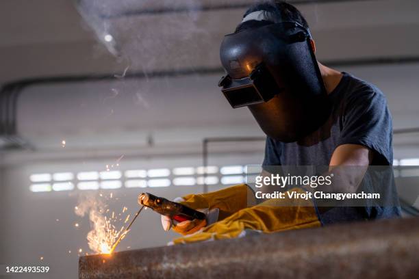 worker working with welding tool - in flames i the mask stock pictures, royalty-free photos & images