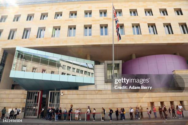 Visitors wait in line outside the British embassy to sign a condolence book for Queen Elizabeth II two days after her death, on September 10, 2022 in...