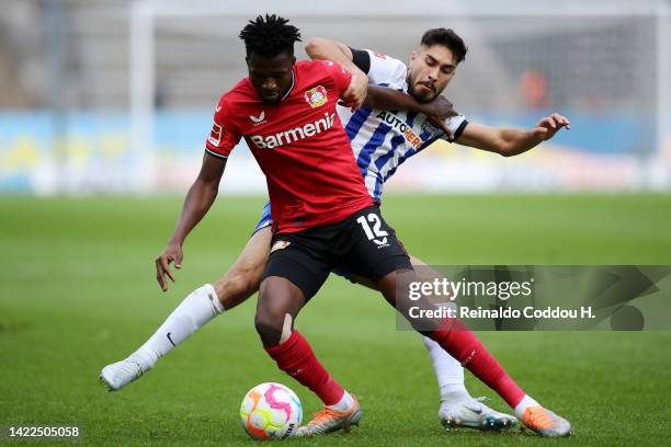 Edmond Tapsoba of Bayer Leverkusen is challenged by Suat Serdar of Hertha BSC during the Bundesliga match between Hertha BSC and Bayer 04 Leverkusen...