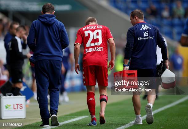 Jonathan Burkardt of FSV Mainz leaves the pitch after receiving medical treatment during the Bundesliga match between TSG Hoffenheim and 1. FSV Mainz...