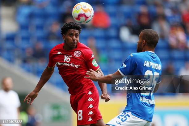 Leandro Barreiro of FSV Mainz heads the ball while under pressure from Kevin Akpoguma of TSG Hoffenheim during the Bundesliga match between TSG...