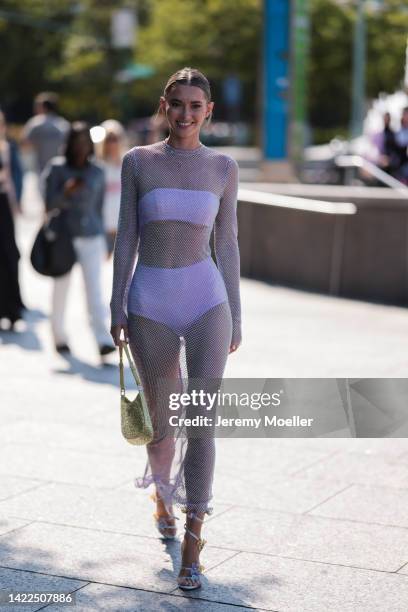 Maddie White seen wearing a purple dress with a prada cleo bag, outside Bronx and Banco Show during New Yorker Fashion W on September 09, 2022 in New...