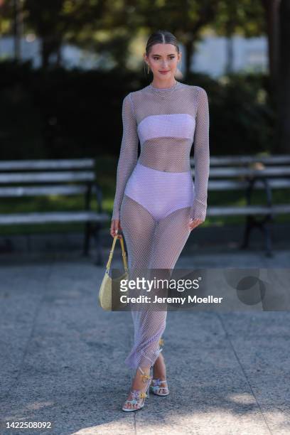 Maddie White seen wearing a purple dress with a prada cleo bag, outside Bronx and Banco Show during New Yorker Fashion W on September 09, 2022 in New...
