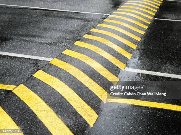 yellow color painted road speed bump - road speed bumps stock pictures, royalty-free photos & images