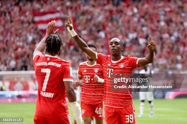 Mathys Tel of Bayern Munich celebrates with teammate after scoring their team's first goal during the Bundesliga match between FC Bayern Muenchen and...