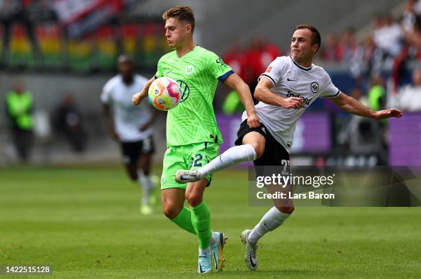 Mattias Svanberg of VfL Wolfsburg battles for possession with Mario Goetze of Eintracht Frankfurt during the Bundesliga match between Eintracht...