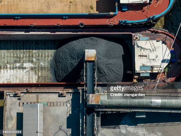 aerial view of industrial ship moored in coal loading dock - coal transport stock pictures, royalty-free photos & images