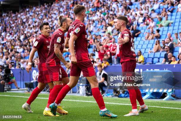 Jose Angel Carmona of Sevilla FC celebrates with teammates after scoring his team's second goal during the LaLiga Santander match between RCD...