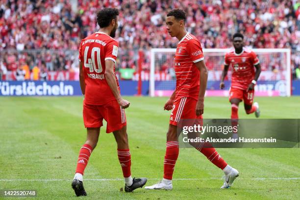 Jamal Musiala of Bayern Munich celebrates with teammate Noussair Mazraoui after scoring their team's second goal during the Bundesliga match between...