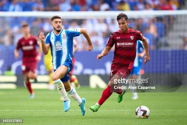 Oliver Torres of Sevilla FC runs with the ball whilst under pressure from Oscar Gil of RCD Espanyol during the LaLiga Santander match between RCD...