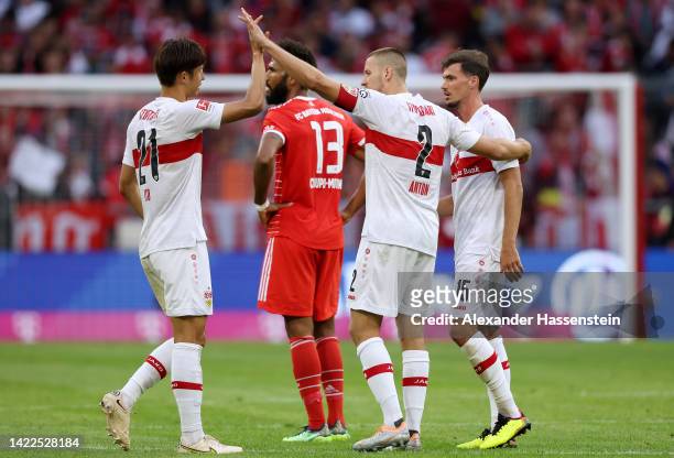Hiroki Ito, Waldemar Anton and Pascal Stenzel of VfB Stuttgart celebrate following the Bundesliga match between FC Bayern Muenchen and VfB Stuttgart...