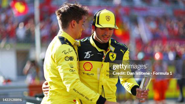 Pole position qualifier Charles Leclerc of Monaco and Ferrari and Third placed qualifier Carlos Sainz of Spain and Ferrari hug in parc ferme during...