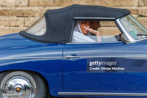 Princess Maria-Laura of Belgium and William Isvy ride a classic Porsche roadster after the wedding ceremony in the Cathedral of St. Michael and St....