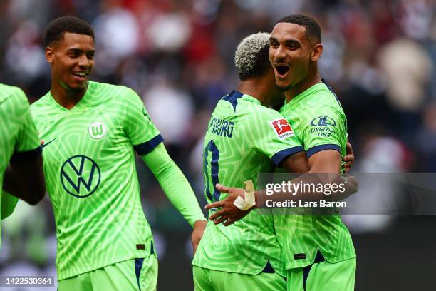 Maxence Lacroix of VfL Wolfsburg celebrates victory with Lukas Nmecha following the Bundesliga match between Eintracht Frankfurt and VfL Wolfsburg at...