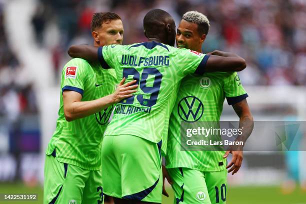 Lukas Nmecha of VfL Wolfsburg celebrates victory with Josuha Guilavogui following the Bundesliga match between Eintracht Frankfurt and VfL Wolfsburg...