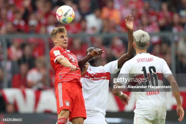 Joshua Kimmich of FC Bayern München battles for the ball with Serhou Guirassy of Stuttgart during the Bundesliga match between FC Bayern München and...