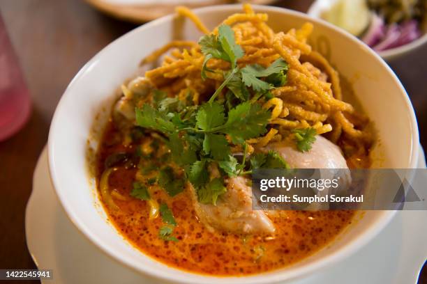 a bowl of thai northern khao soi curry noodle - thai food stock pictures, royalty-free photos & images