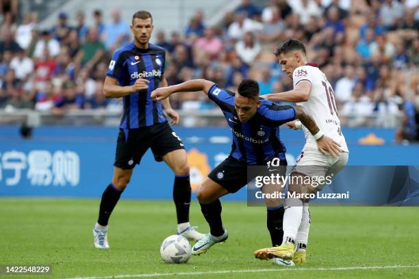 Lautaro Martinez of FC Internazionale is challenged by Sasa Lukic of Torino FC during the Serie A match between FC Internazionale and Torino FC at...