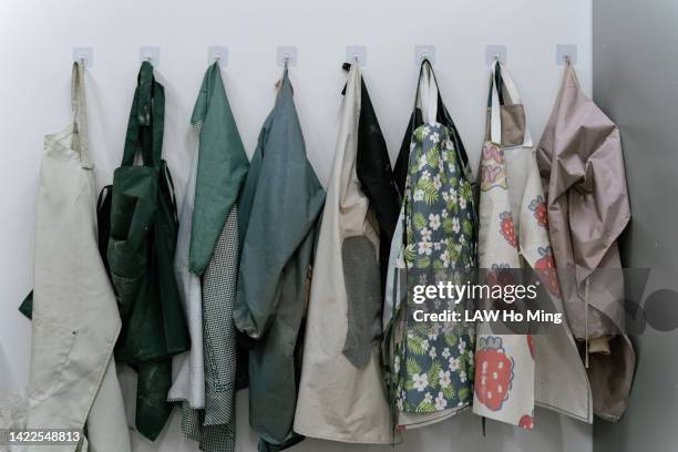 the aprons hanging on hooks - apron isolated stockfoto's en -beelden