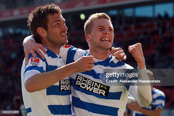 Andre Hoffmann of Duisburg celebrates scoring the opening goal with his team mate Goran Sukalo during the Second Bundesliga match between FC...