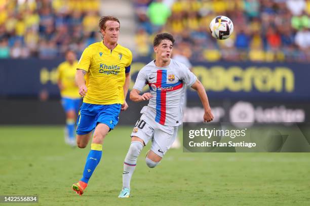 Gavi of FC Barcelona battles for possession with Alex Fernandez of Cadiz CF during the LaLiga Santander match between Cadiz CF and FC Barcelona at...