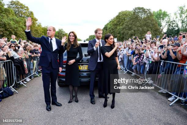 Catherine, Princess of Wales, Prince William, Prince of Wales, Prince Harry, Duke of Sussex, and Meghan, Duchess of Sussex wave to crowd on the long...
