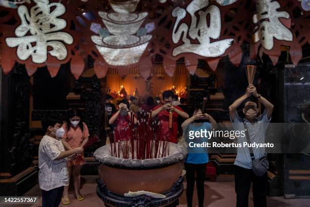 Devotees pray during the Mid-Autumn celebration at Sanggar Agung temple on September 10, 2022 in Surabaya, Indonesia. Mid-Autumn festival is one of...