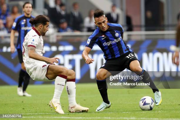 Lautaro Martinez of FC Internazionale is challenged by Ricardo Rodriguez of Torino FC during the Serie A match between FC Internazionale and Torino...