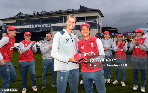 England player Lauren Bell receives her cap from Sophia Dunkley prior to the 1st Vitality IT20 match between England and India at Seat Unique...