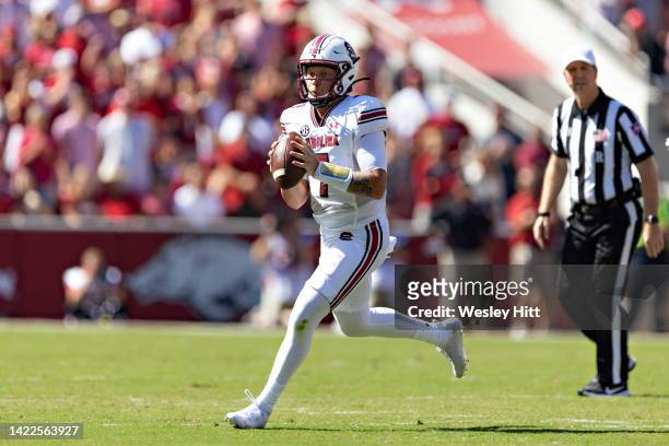 Spencer Rattler of the South Carolina Gamecocks rolls out looking for a receiver during the first half of a game against the Arkansas Razorbacks at...