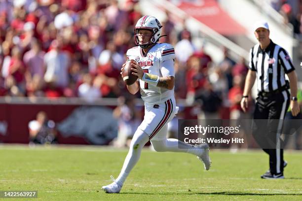 Spencer Rattler of the South Carolina Gamecocks rolls out looking for a receiver during the first half of a game against the Arkansas Razorbacks at...