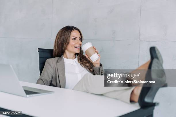 relaxing after a job well done! - feet on desk stock pictures, royalty-free photos & images