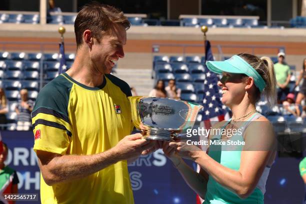 Storm Sanders of Australia and John Peers of Australia celebrate with the championship trophy after defeating Kirsten Flipkens of Belgium and Edouard...