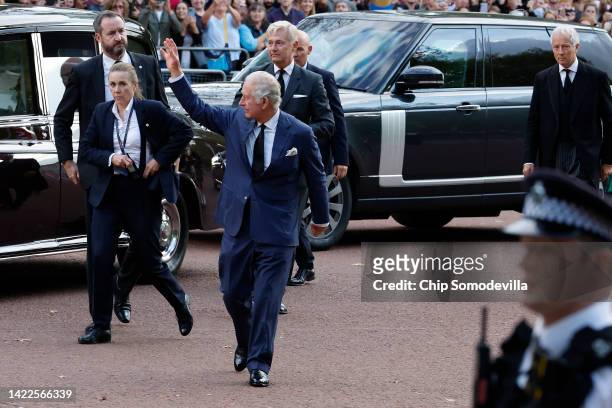 King Charles III steps from his motorcade and waves to supporters during an impromptu walkabout on the Mall outside of St. James Palace following the...