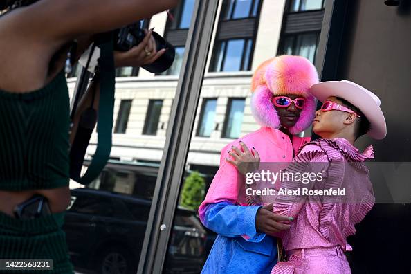 Devin Thorpe wearing a rainbow jacket, fur hat and bag by Louis News  Photo - Getty Images