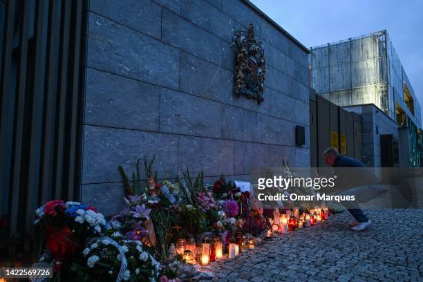 Man photographs flowers for the late Queen Elizabeth II at the British Embassy on September 10, 2022 in Warsaw, Poland. Queen Elizabeth II, the UK's...