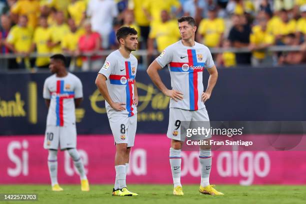 Pedri and Robert Lewandowski of FC Barcelona wait after there is a medical emergency inside the stadium during the LaLiga Santander match between...