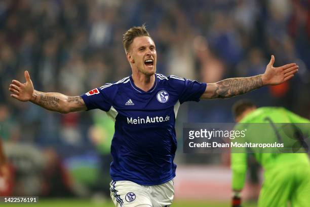 Sebastian Polter of FC Schalke 04 celebrates after scoring their sides third goal during the Bundesliga match between FC Schalke 04 and VfL Bochum...