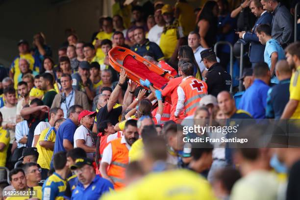 Medical staff are seen assisting a patient in the stands as the match is interrupted during the LaLiga Santander match between Cadiz CF and FC...