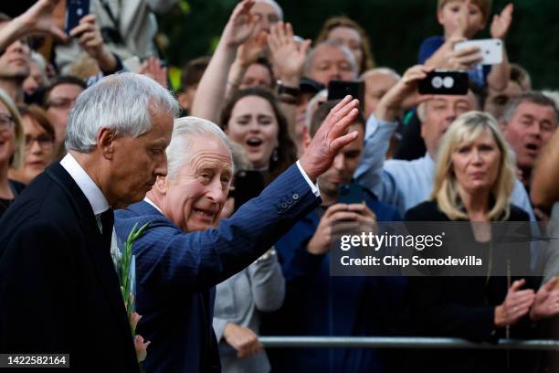 King Charles III waves to supporters during an impromptu walkabout on the Mall outside of St. James Palace following the death of his mother Queen...