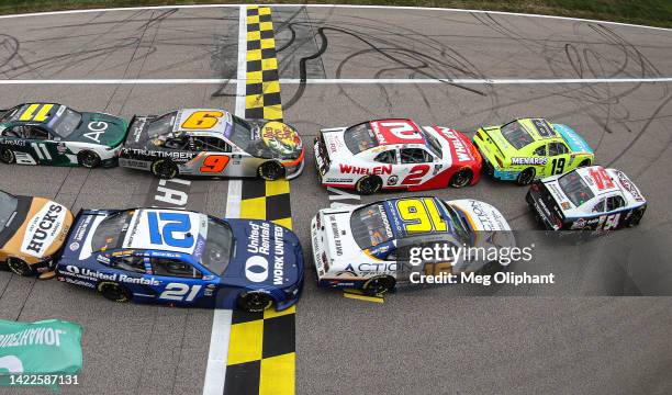 Brandon Jones, driver of the Menards/Klearvue Cabinetry Toyota, leads the field the field to the green flag to start the NASCAR Xfinity Series Kansas...